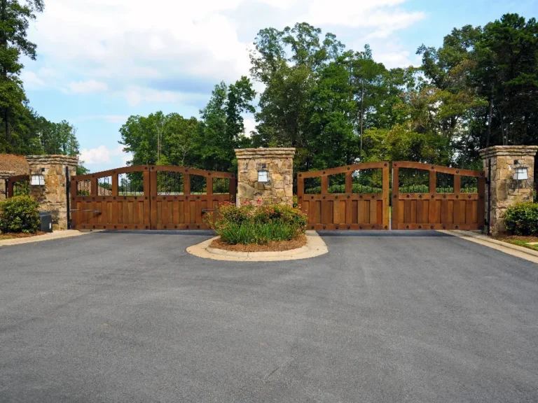 gated community entrance with two sets of wooden gates in Dallas Texas